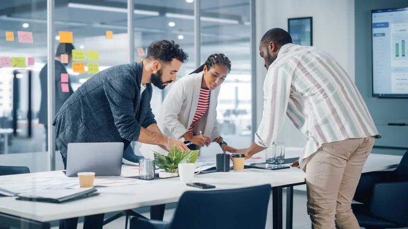 A team gathered around a table reviewing a growth plan