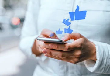 Thumbs-up reactions rising from a phone