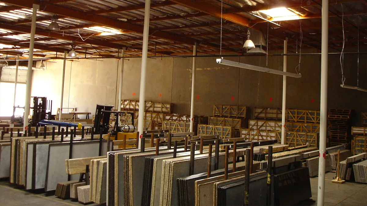 Before: Superior Stone & Cabinet's original warehouse with stone slabs in tight rows